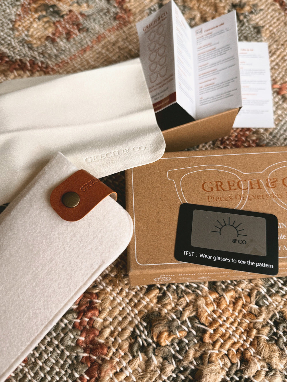 What comes with every pair of GRECH & CO. sunglasses: the gift box, a felt case with a leather tab, a cleaning cloth, the care booklet and a polarization test card